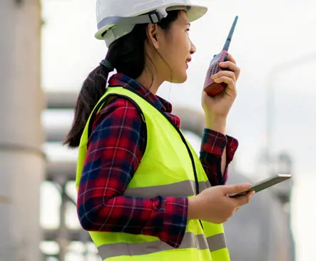 Construction worker talking on a walkie talkie