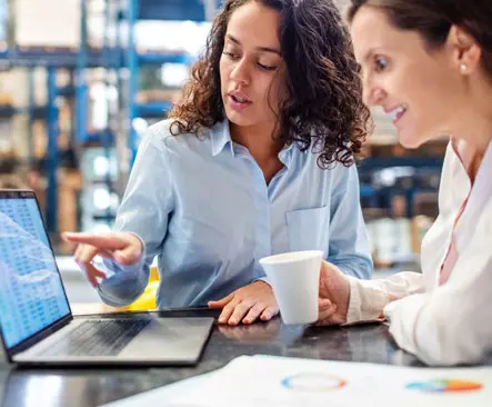 Two women looking at a laptop