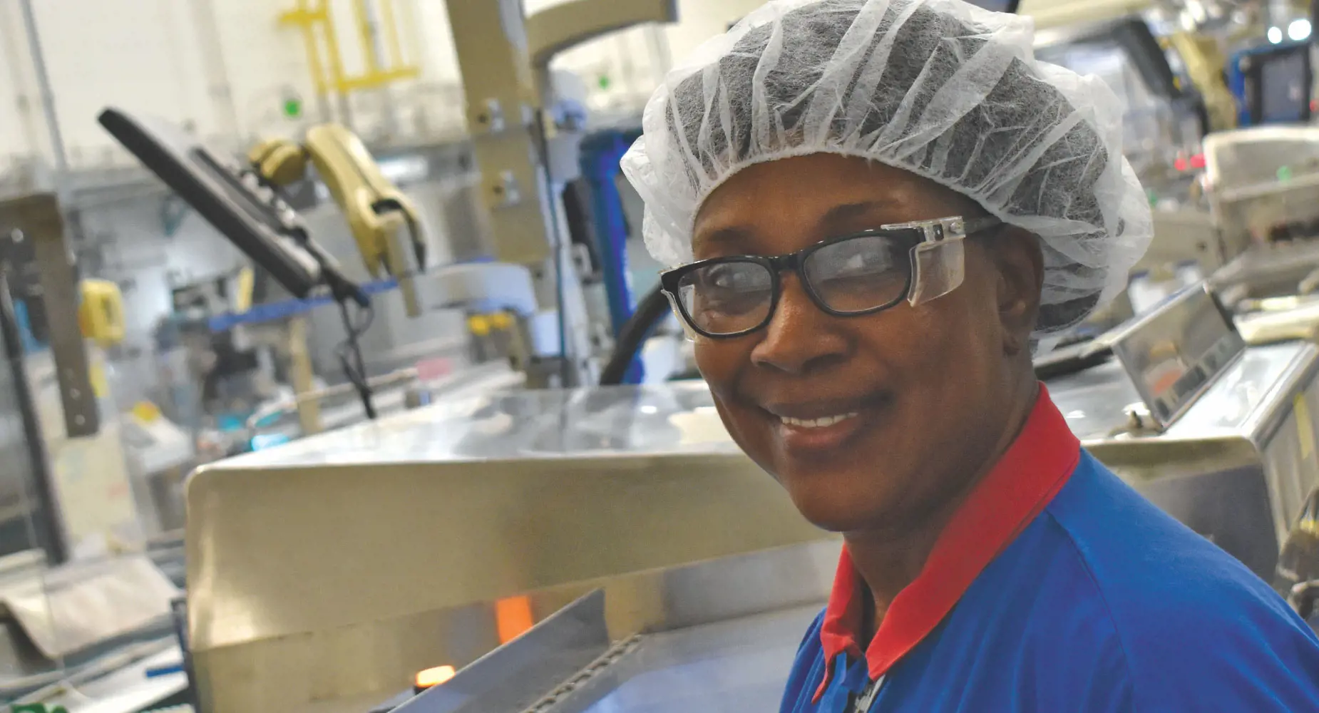 Woman in hairnet working at a machine
